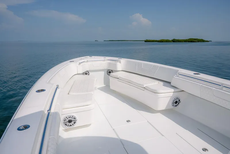 Slide: The Image of 2022 Contender 39 ST boat interior with cushioned seating on calm water. - 21