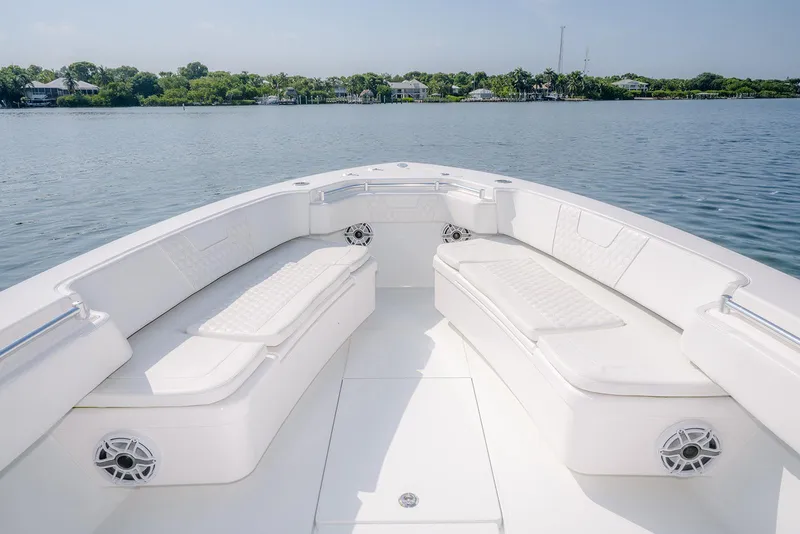 Slide: The Image of 2022 Contender 39 ST boat speeding on open water under clear skies. - 22