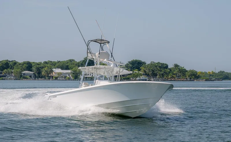 Slide: The Image of 2022 Contender 39 ST boat cruising on open water, clear sky background. - 24