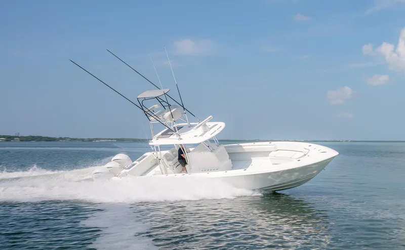 Slide: The Image of 2022 Contender 39 ST boat on calm water under blue sky. - 25