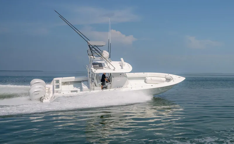 Slide: The Image of 2022 Contender 39 ST boat speeding on open water under clear skies. - 26