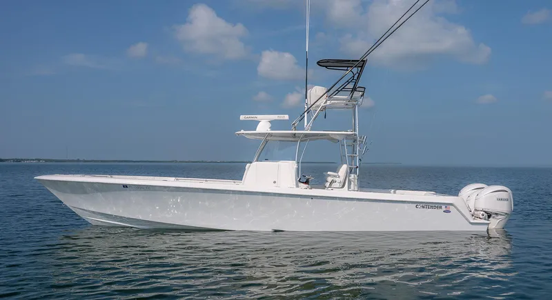 Slide: The Image of 2022 Contender 39 ST boat on calm water under blue sky. - 28