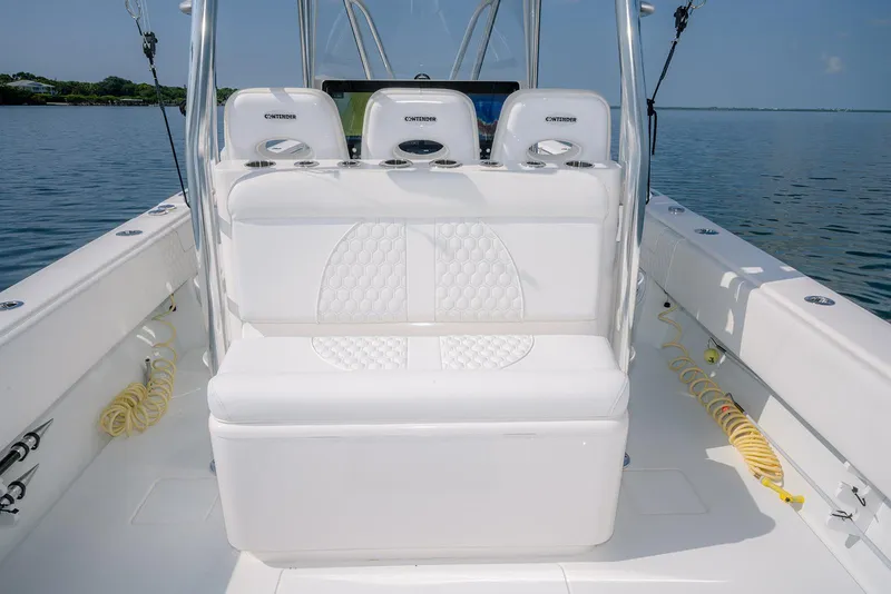 Slide: The Image of 2022 Contender 39 ST boat interior with white seating and ocean backdrop. - 7