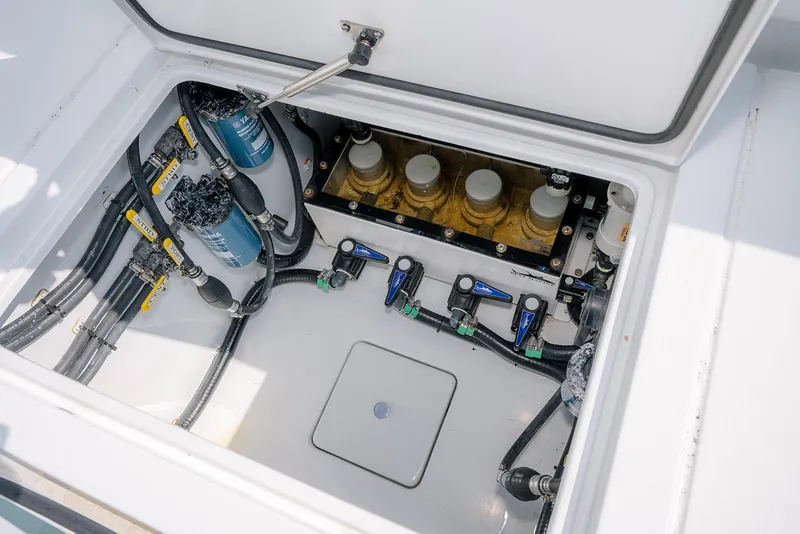Slide: The Image of Contender 39 ST 2022 boat compartment with advanced filtration system and valves. - 9