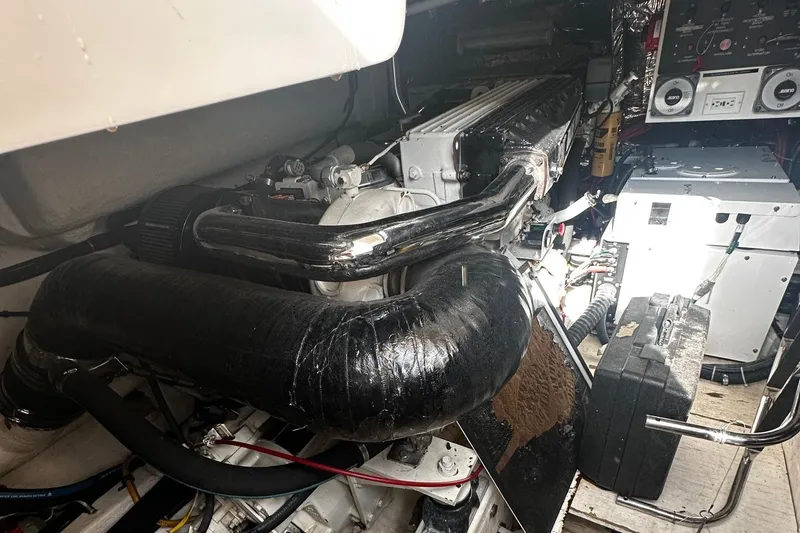 Slide: The Image of Engine room of 1999 Tiara Yachts 43 Open, showcasing mechanical components and wiring. - 10