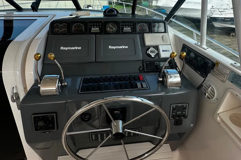 Slide: The Image of 1999 Tiara Yachts 43 Open helm with Raymarine electronics and dual throttle controls. - 13