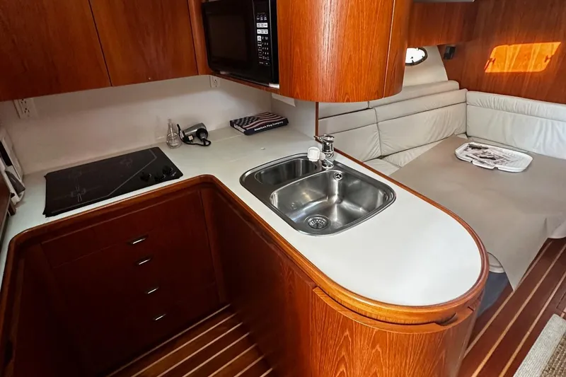 Slide: The Image of 1999 Tiara Yachts 43 Open interior with kitchen and seating area. - 17