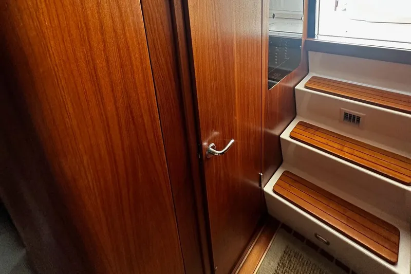 Slide: The Image of Interior of 1999 Tiara Yachts 43 Open, featuring wooden cabinetry and steps. - 25