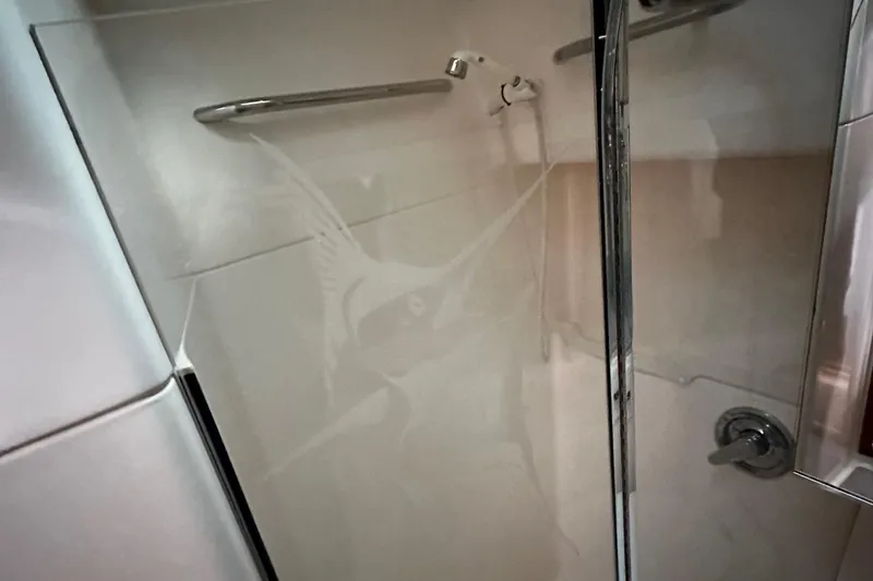 Slide: The Image of Shower area in 1999 Tiara Yachts 43 Open, featuring sleek glass door and chrome fixtures. - 27