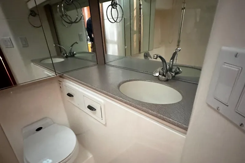Slide: The Image of Bathroom interior of 1999 Tiara Yachts 43 Open, featuring sink and toilet. - 28