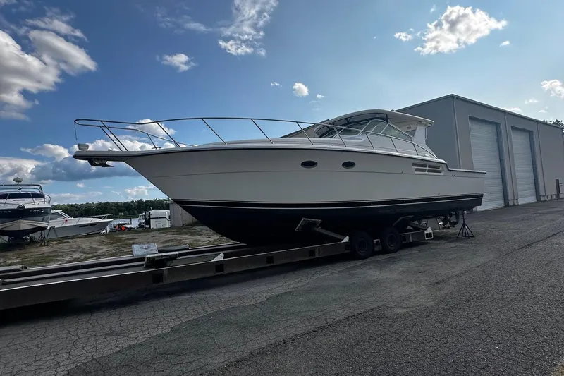 Slide: The Image of 1999 Tiara Yachts 43 Open boat on trailer, parked near storage facility. - 3