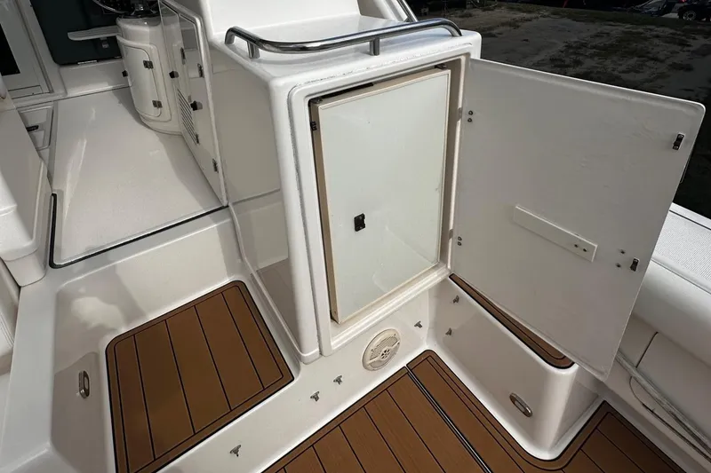 Slide: The Image of 1999 Tiara Yachts 43 Open interior with open storage compartment and teak flooring. - 8