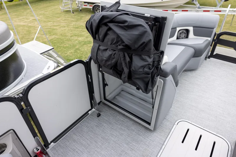Slide: The Image of 2025 Premier 230 Solaris RF boat interior with storage compartment and seating. - 14