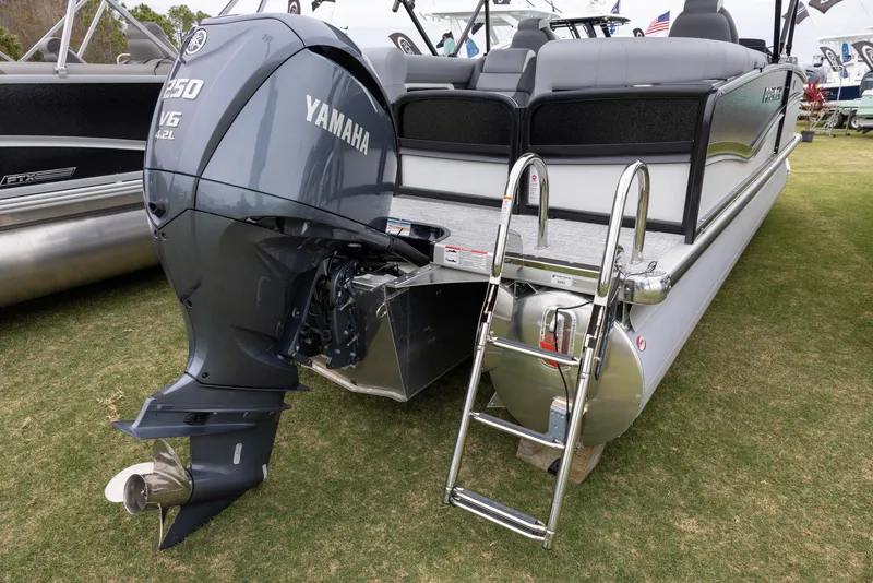 Slide: The Image of 2025 Premier 230 Solaris RF pontoon boat with Yamaha outboard motor and ladder. - 3