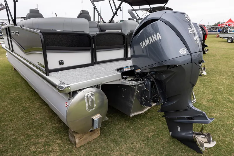 Slide: The Image of 2025 Premier 230 Solaris RF pontoon boat with Yamaha outboard motor displayed on grass. - 4