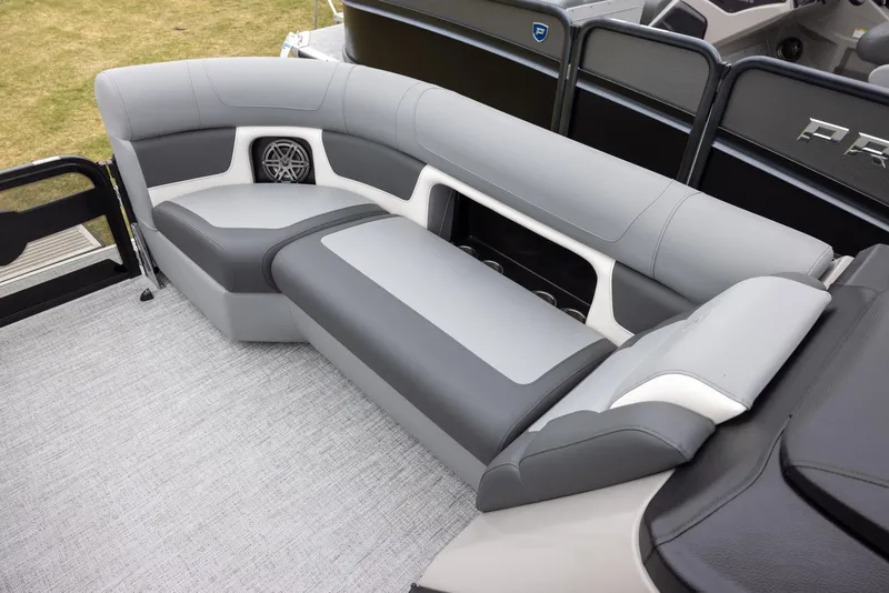 Slide: The Image of 2025 Premier 230 Solaris RF boat interior with gray seating and speaker system. - 6