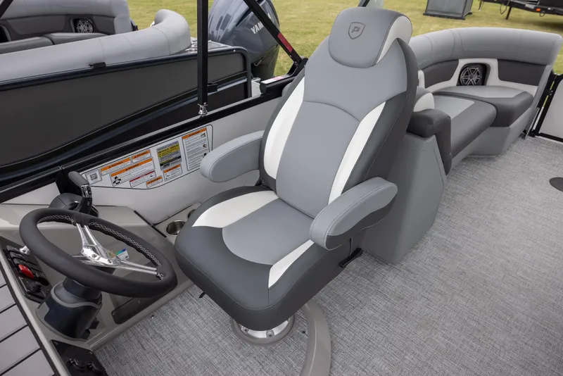 Slide: The Image of 2025 Premier 230 Solaris RF boat interior with gray captain's chair and steering wheel. - 9