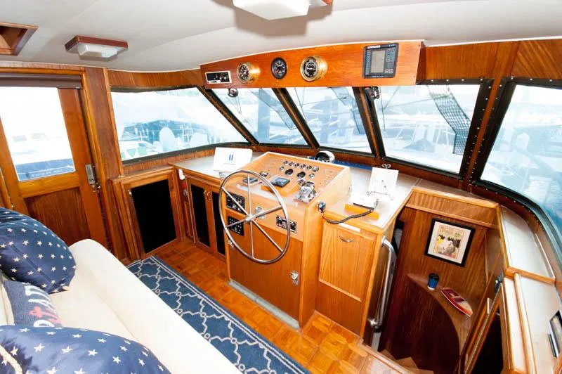 Slide: The Image of 1980 Hatteras 58 Motor Yacht helm with wooden dashboard and steering wheel. - 10
