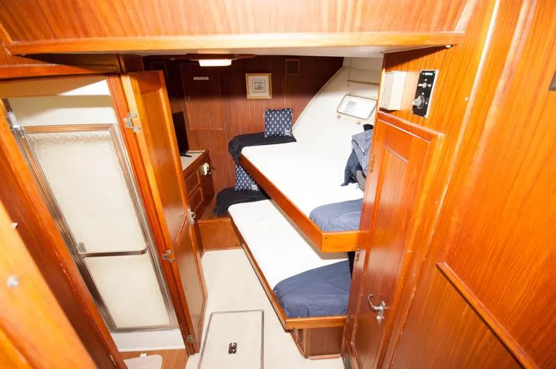 Slide: The Image of Interior of 1980 Hatteras 58 Motor Yacht with wooden bunk beds and cabinetry. - 12