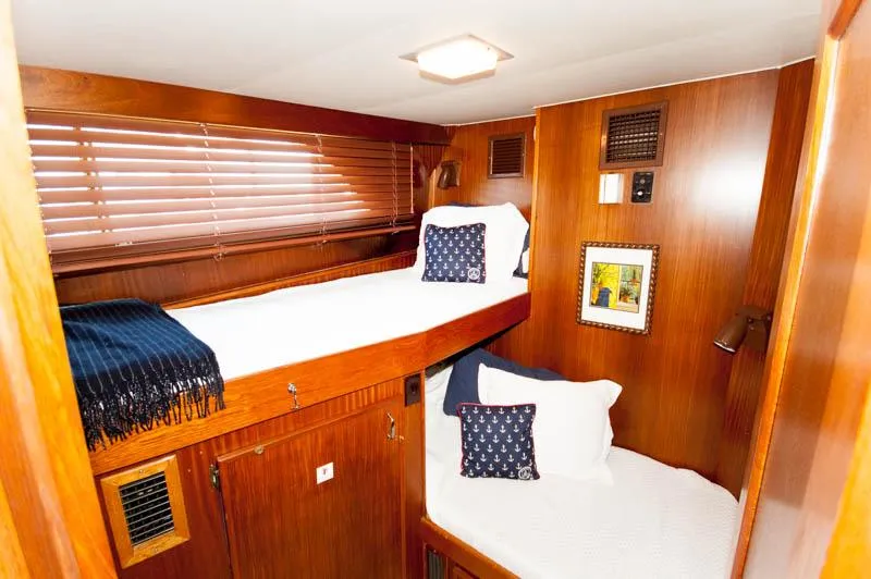 Slide: The Image of 1980 Hatteras 58 Motor Yacht cabin with wooden interior and cozy twin beds. - 14