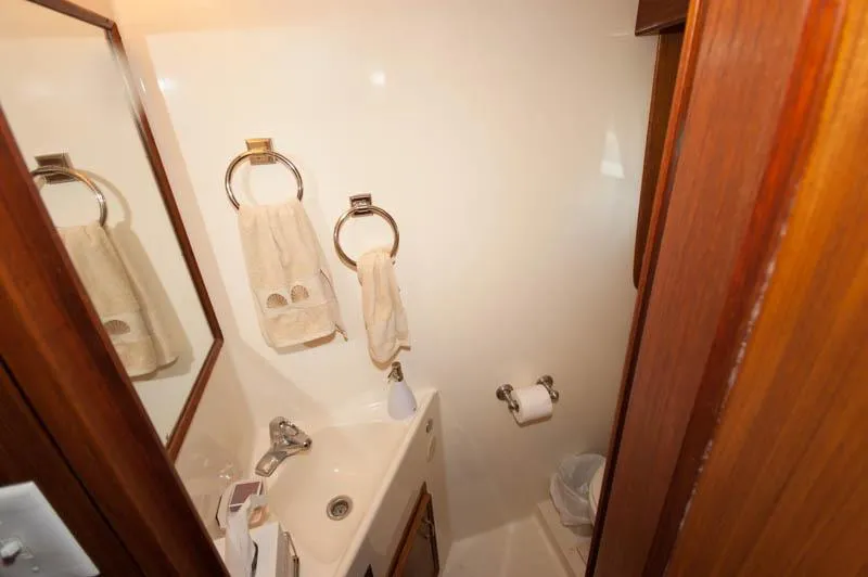 Slide: The Image of 1980 Hatteras 58 Motor Yacht bathroom with sink, mirror, and towel rings. - 15