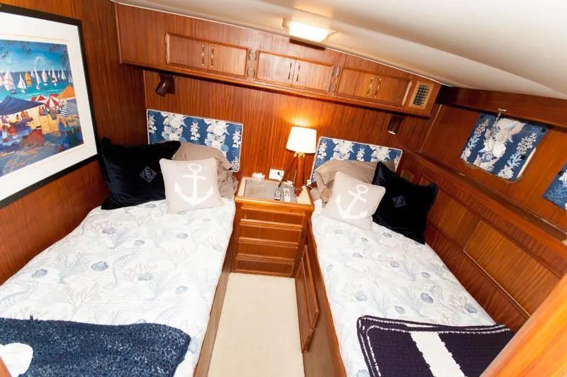 Slide: The Image of Interior of 1980 Hatteras 58 Motor Yacht with twin beds and nautical decor. - 16