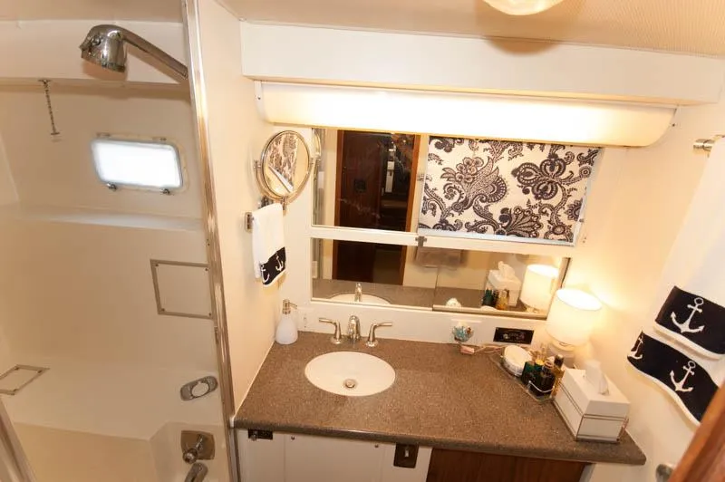 Slide: The Image of Bathroom interior of 1980 Hatteras 58 Motor Yacht with nautical decor and modern amenities. - 17