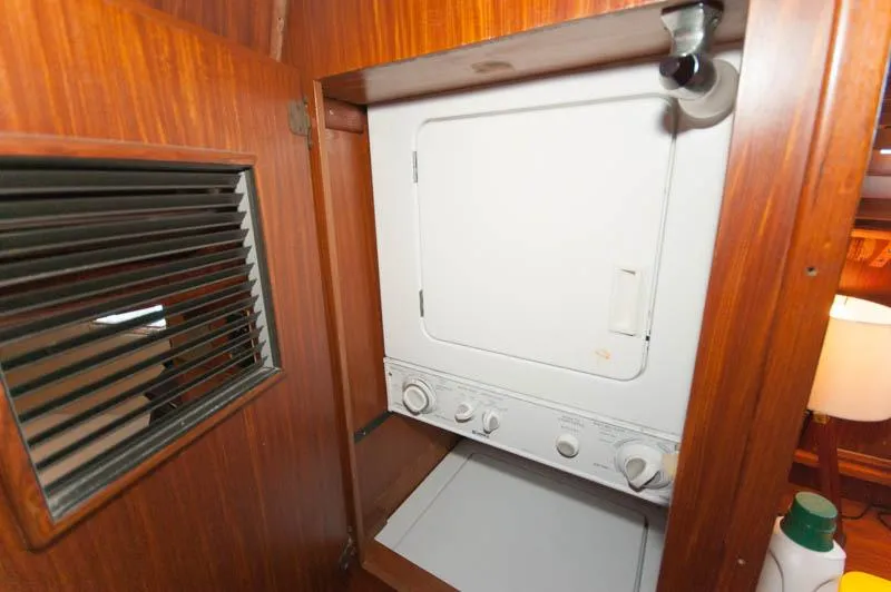Slide: The Image of Laundry area inside 1980 Hatteras 58 Motor Yacht with wooden cabinetry. - 21