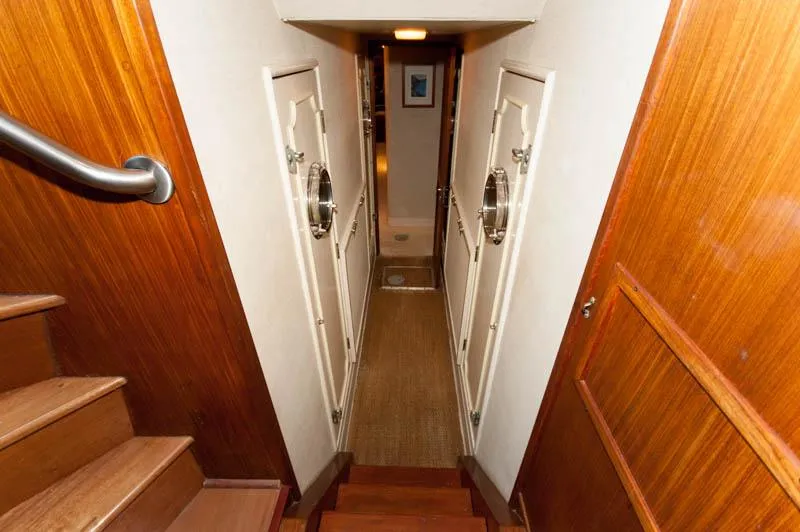 Slide: The Image of Interior hallway of 1980 Hatteras 58 Motor Yacht with wooden stairs and doors. - 23