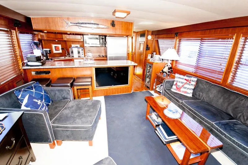 Slide: The Image of Interior of 1980 Hatteras 58 Motor Yacht with cozy seating and wooden accents. - 25