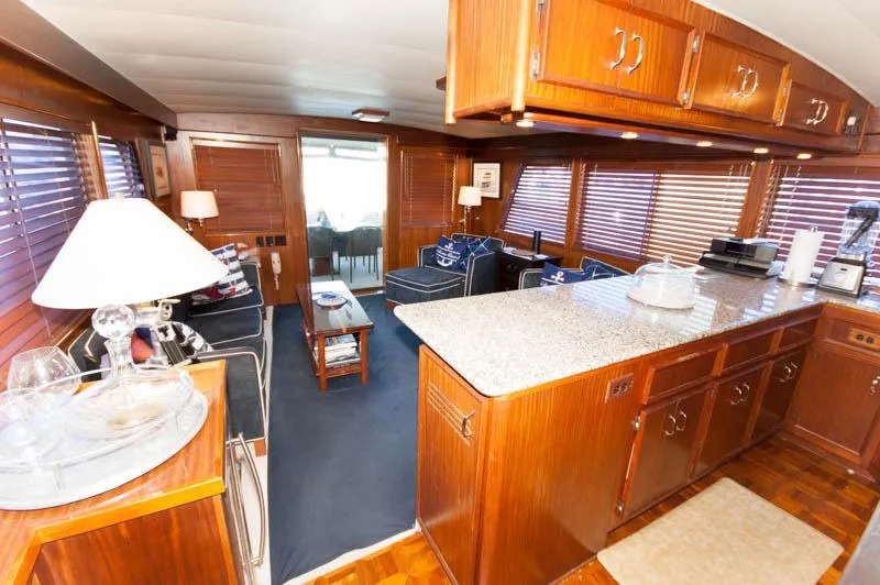Slide: The Image of 1980 Hatteras 58 Motor Yacht interior with wood paneling and spacious living area. - 26
