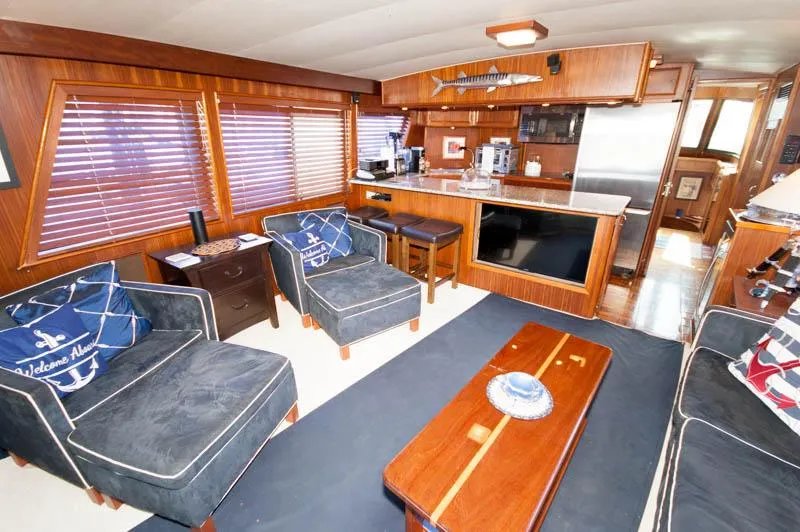 Slide: The Image of Interior of 1980 Hatteras 58 Motor Yacht with elegant wood finish and cozy seating. - 27