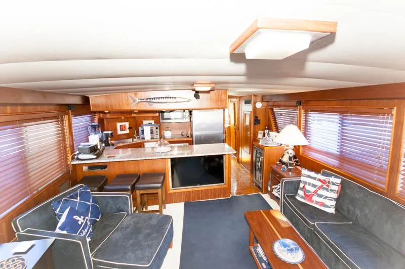 Slide: The Image of Interior of 1980 Hatteras 58 Motor Yacht with cozy seating and wooden finishes. - 28