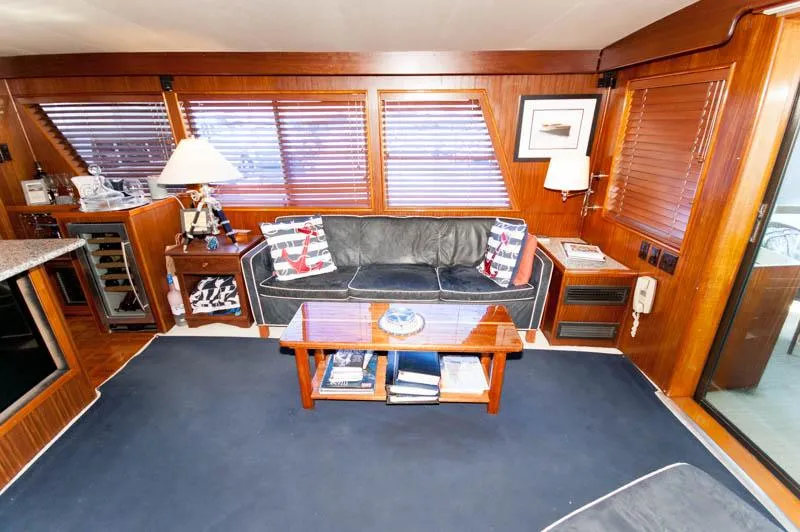 Slide: The Image of Luxurious interior of 1980 Hatteras 58 Motor Yacht with leather sofa and nautical decor. - 29