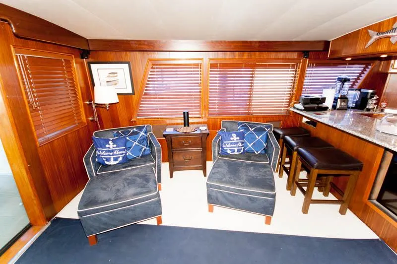 Slide: The Image of Interior of 1980 Hatteras 58 Motor Yacht with cozy seating and wooden accents. - 30