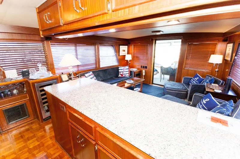 Slide: The Image of Luxurious interior of 1980 Hatteras 58 Motor Yacht with elegant wood finishes and modern amenities. - 31