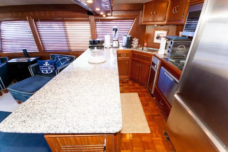 Slide: The Image of 1980 Hatteras 58 Motor Yacht kitchen with granite countertops and wooden cabinetry. - 32