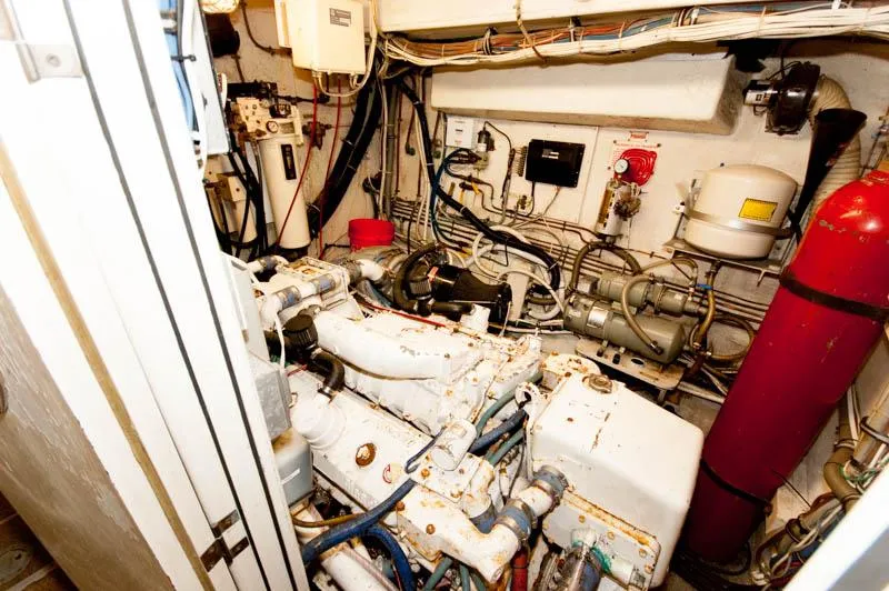 Slide: The Image of Engine room of 1980 Hatteras 58 Motor Yacht, featuring complex machinery and wiring. - 36