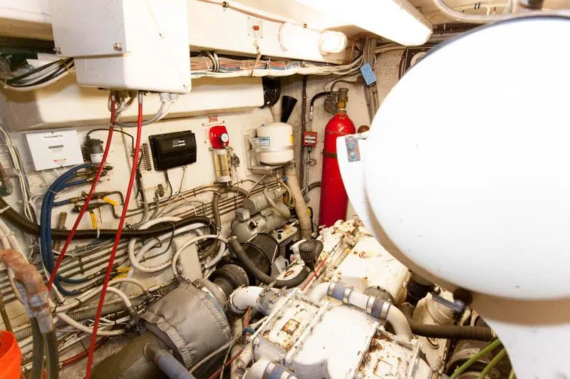 Slide: The Image of Engine room of a 1980 Hatteras 58 Motor Yacht, showcasing machinery and equipment. - 39