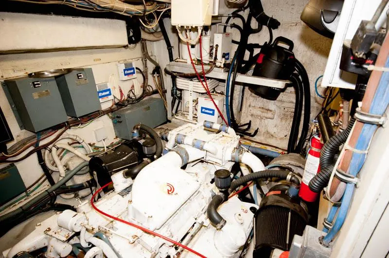 Slide: The Image of Engine room of a 1980 Hatteras 58 Motor Yacht, showcasing mechanical components and wiring. - 41