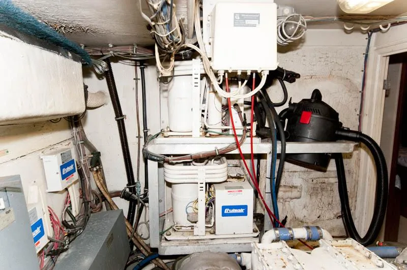 Slide: The Image of Engine room of a 1980 Hatteras 58 Motor Yacht with electrical equipment and wiring. - 43