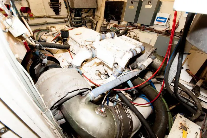 Slide: The Image of Engine room of a 1980 Hatteras 58 Motor Yacht with visible machinery and wiring. - 45