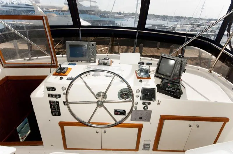Slide: The Image of 1980 Hatteras 58 Motor Yacht helm with navigation equipment and steering wheel. - 48