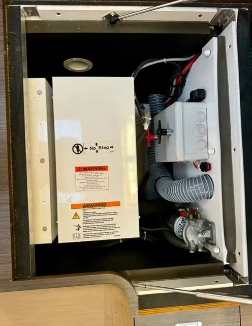 Slide: The Image of Electrical compartment of a 2016 Jeanneau 58 yacht, featuring wiring and warning labels. - 15