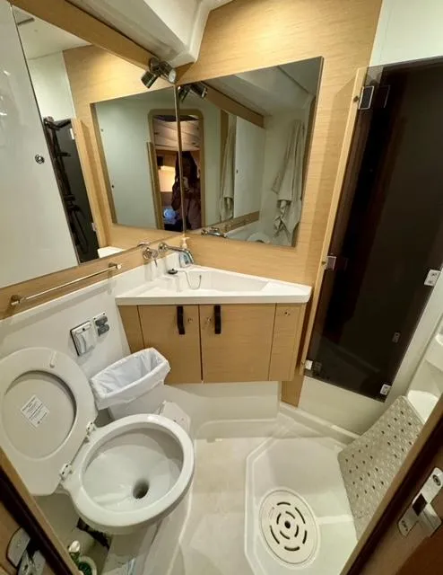 Slide: The Image of Bathroom interior of a 2016 Jeanneau 58 yacht, featuring modern fixtures and a compact design. - 20