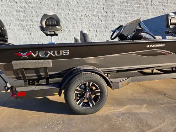 Slide: The Image of 2025 Vexus AVX1980C boat on trailer, sleek design, black finish, outdoor setting. - 4