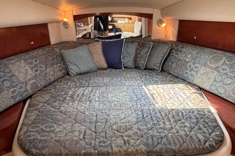 Slide: The Image of Luxurious cabin interior of 2004 Sea Ray 320 Sundancer with cozy bedding and cushions. - 12