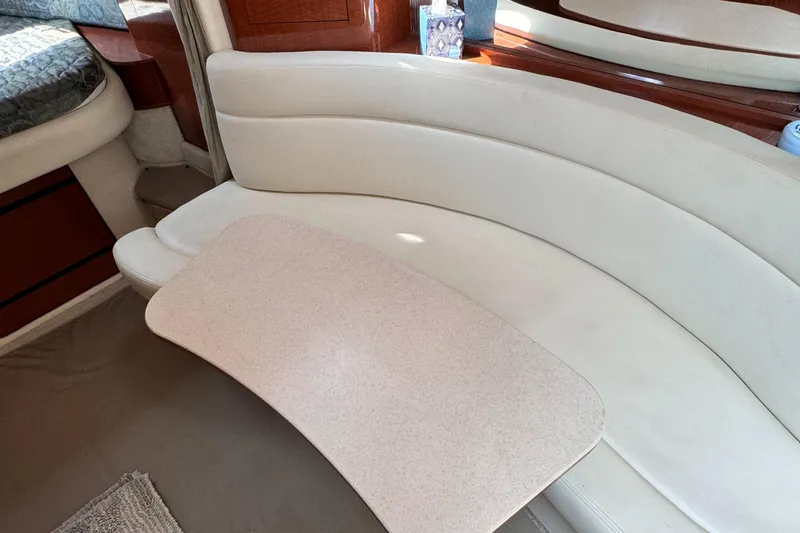 Slide: The Image of Interior of 2004 Sea Ray 320 Sundancer with cream leather seating and table. - 15