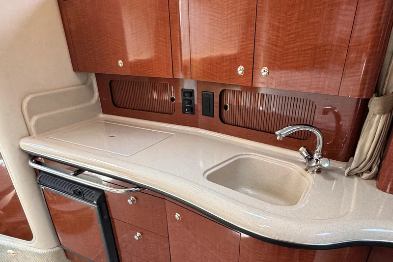 Slide: The Image of Luxurious 2004 Sea Ray 320 Sundancer yacht kitchen with sleek cabinetry and modern sink. - 16