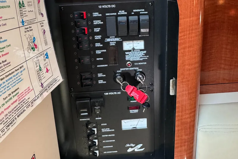 Slide: The Image of Control panel of a 2004 Sea Ray 320 Sundancer boat with switches and keys. - 18